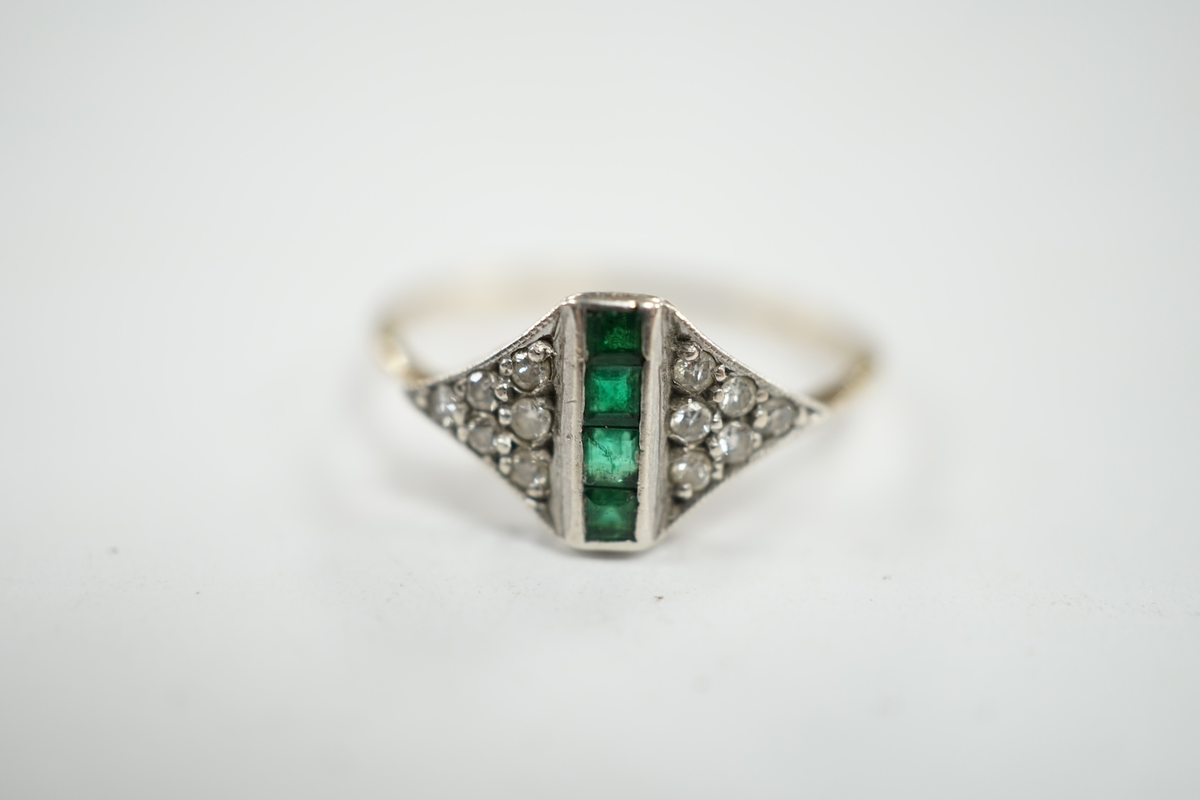 A small early 20th century 15ct, emerald and diamond cluster set ring, size P, gross weight 1.6 grams. Condition - fair